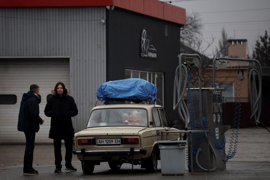 Local residents are seen refueling at gas station after Russian President Vladimir Putin authorized a military operation in eastern Ukraine, in Mariupol