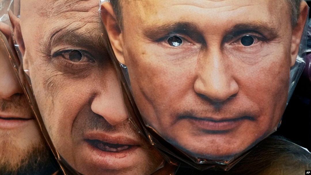 Masks depicting Russian President Vladimir Putin (right) and Wagner chief Yevgeny Prigozhin are displayed for sale at a souvenir shop in St. Petersburg in June 4.
