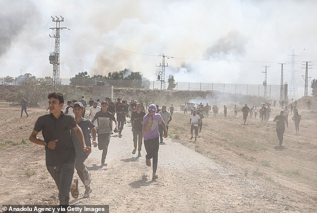 People flee as clashes flare between Palestinian groups and Israeli forces in Gaza City following the earlier air strikes