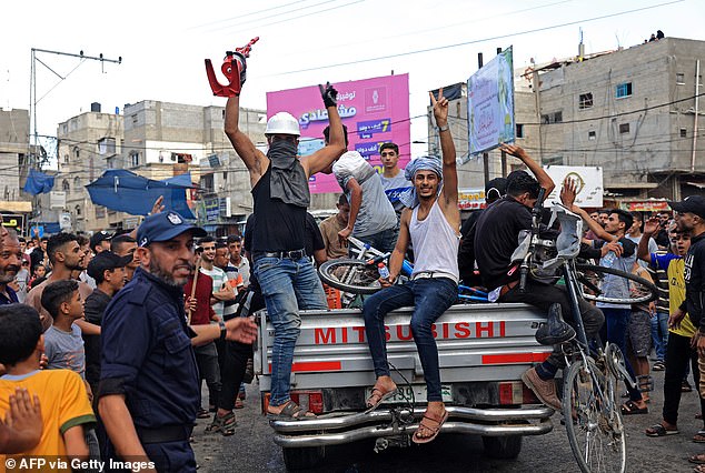 Palestinians are greeted by crowds after returning from crossing the border into Israel