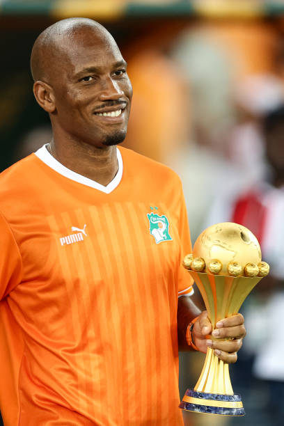former-ivorian-footballer-didier-drogba-carries-the-trophy-ahead-of-the-africa-cup-of-nations.jpg