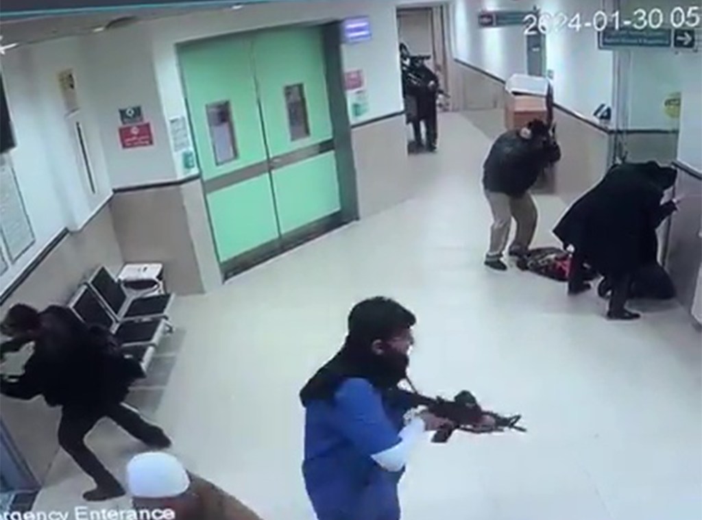 Israeli commandos seen passing through a hospital hallway with guns drawn