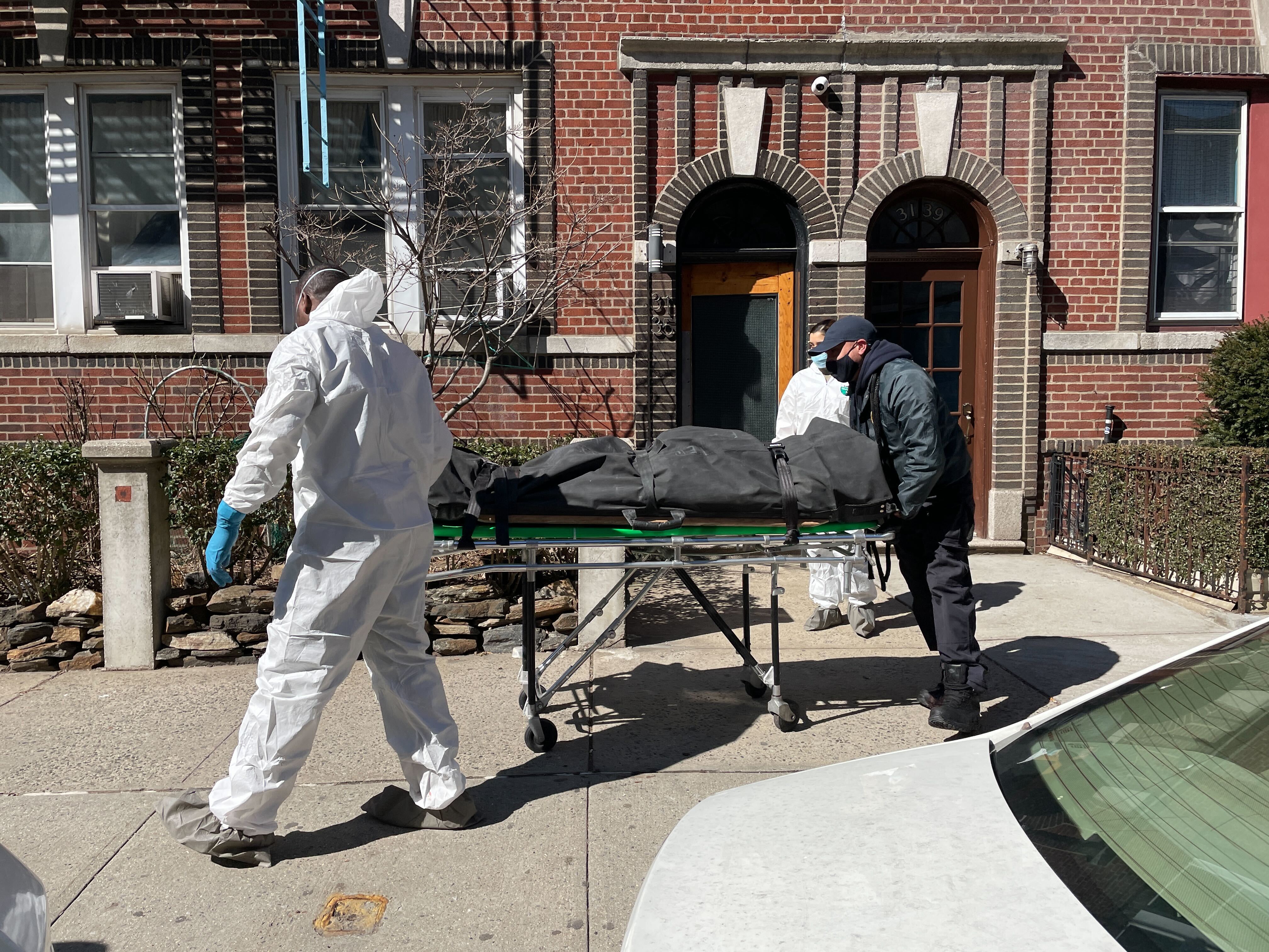 Workers from New York City's medical examiner's office remove Jonathan Hutcherson's body.