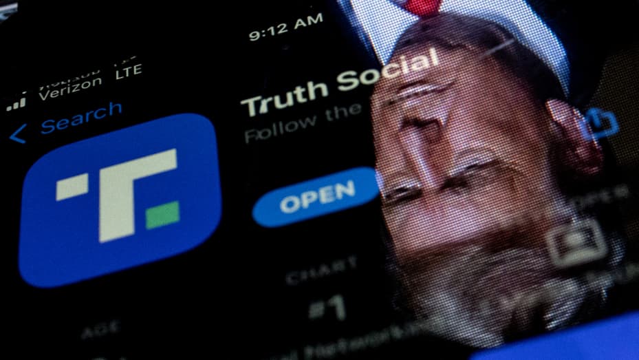 This photo illustration shows an image of former President Donald Trump reflected in a phone screen that is displaying the Truth Social app, in Washington, DC, on February 21, 2022.