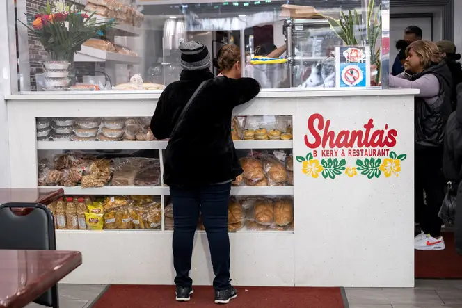 A person orders at the counter of Shanta’s Bakery and Restaurant.