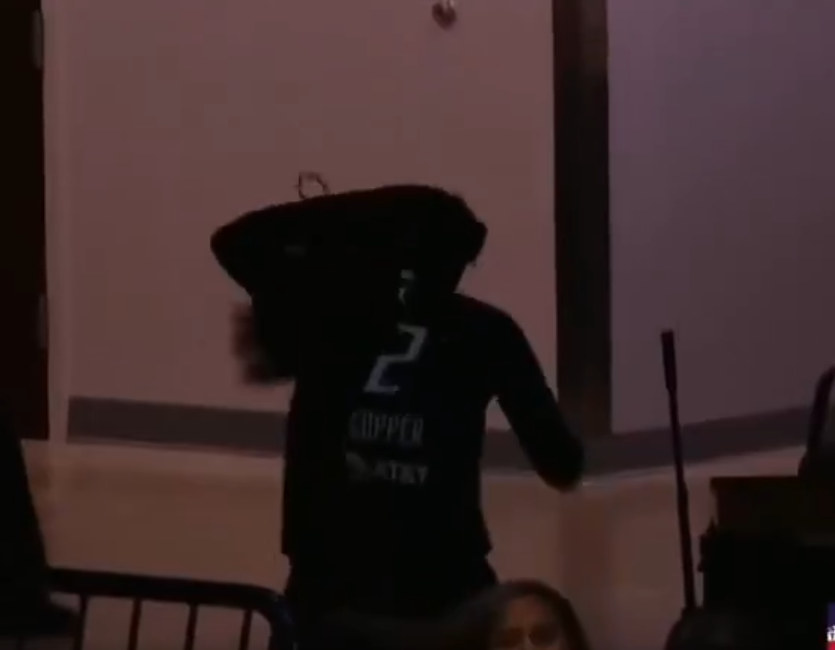 Kahleah Copper runs to the locker room after wig falls off.