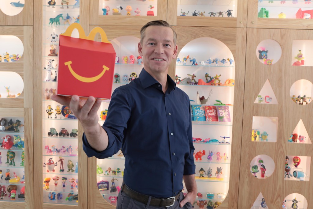 McDonald's CEO Chris Kempczinski holding a Happy Meal at McDonald's Headquarters in Chicago