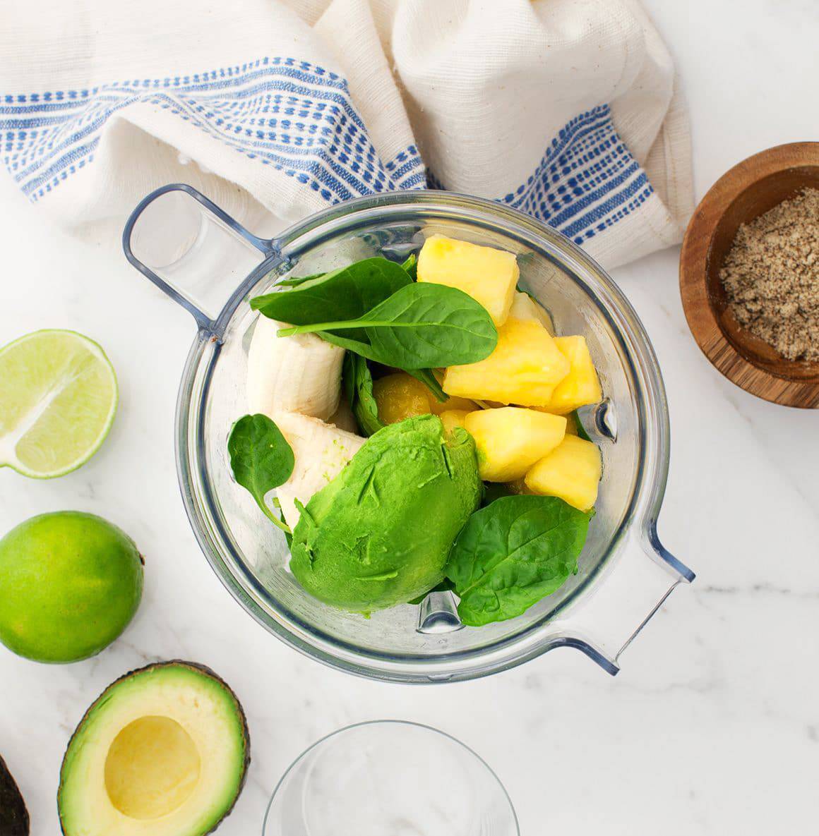 Avocado, banana, pineapple, and spinach in a blender