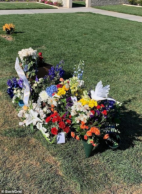 12217080-6917815-Nipsey_Hussle_s_grave_site_covered_with_flowers_following_a_fune-m-51_1555119691725.jpg