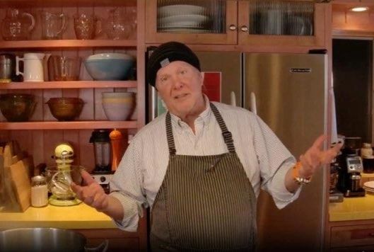 Mario Batali in his kitchen with his apron. 
