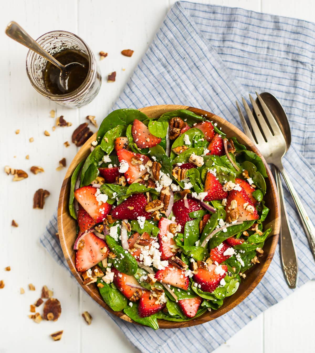 A light, bright, easy salad in a bowl with fresh fruit, cheese, and nuts