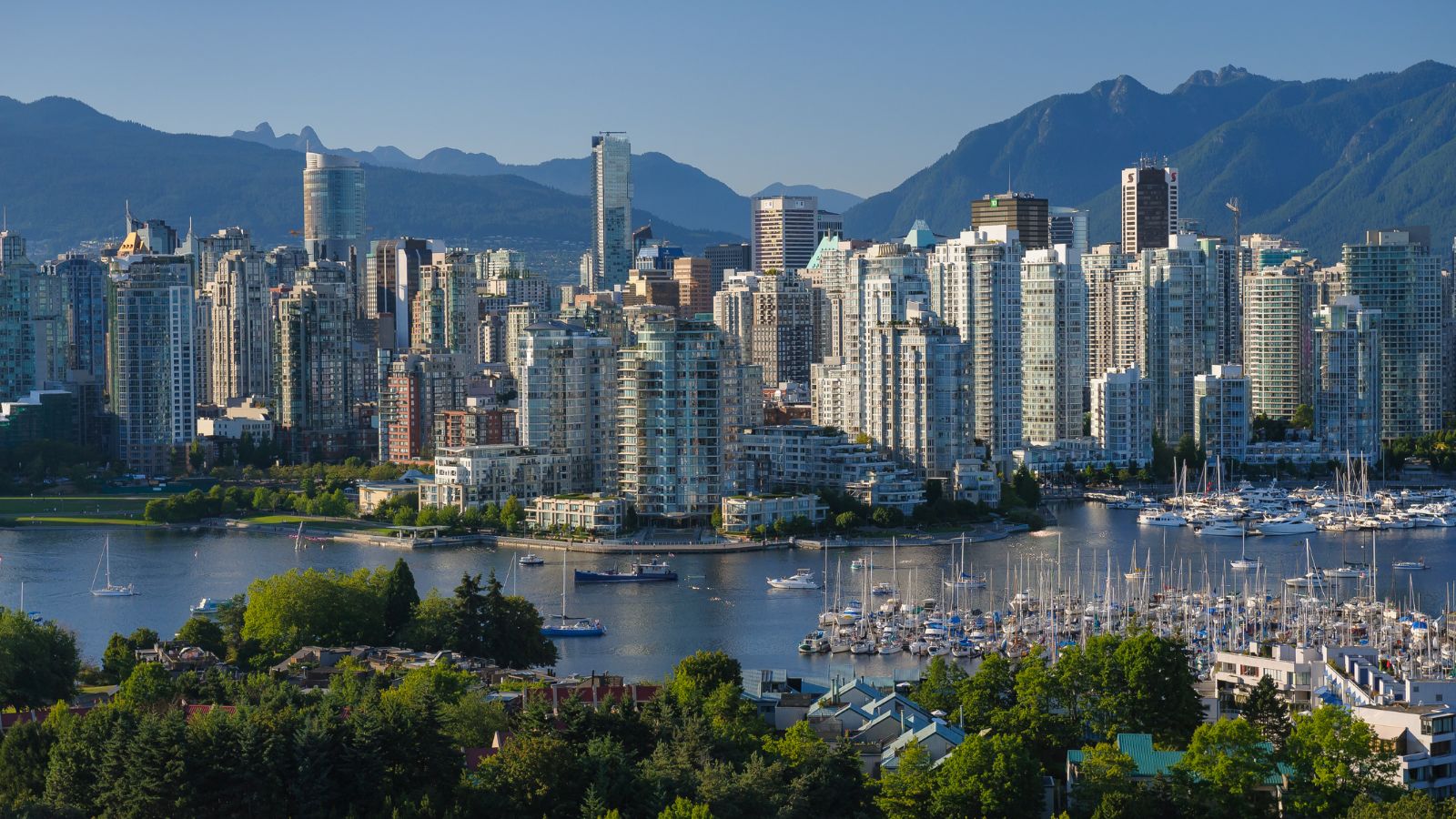 a city with many tall buildings and boats on water