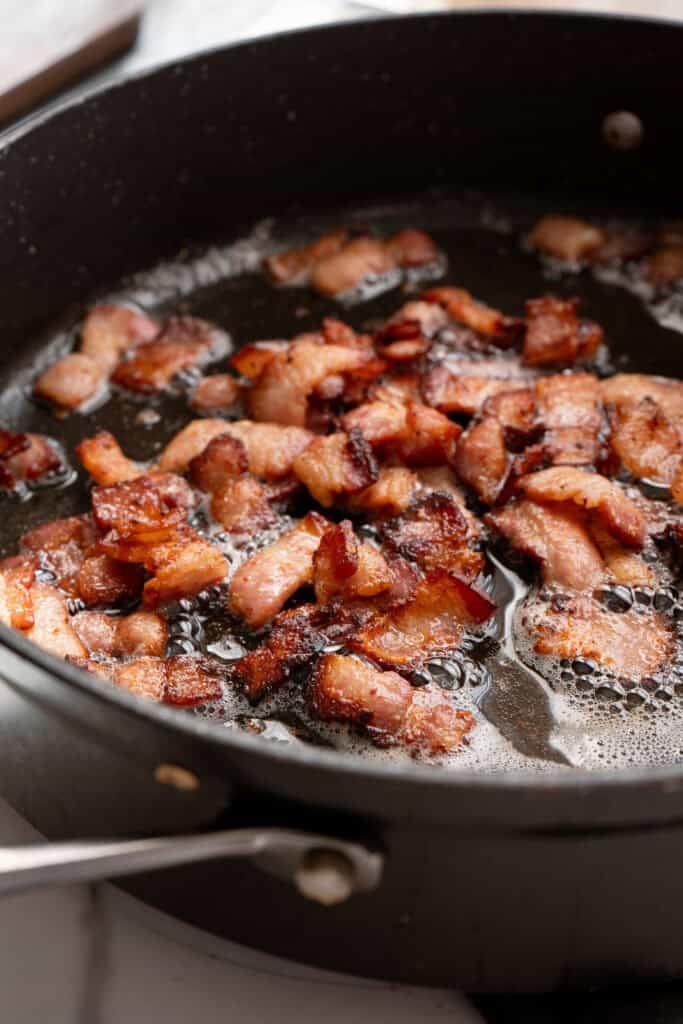bacon cooking in a skillet.