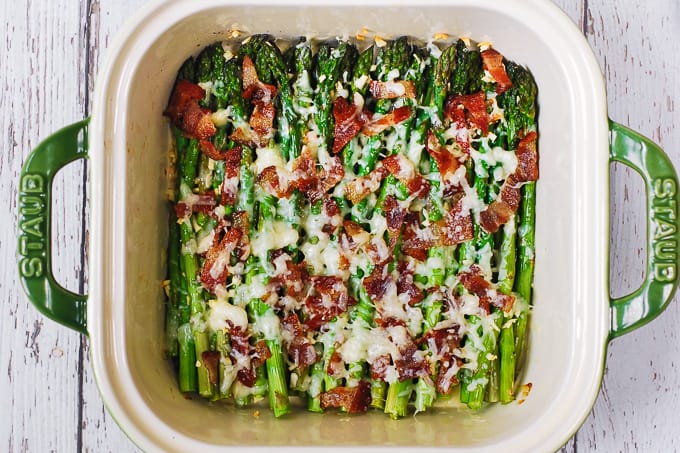 Asparagus with melted cheese in a casserole dish