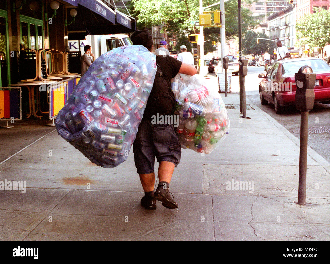 homeless-man-collecting-tin-cans-to-recycle-for-money-A1K475.jpg