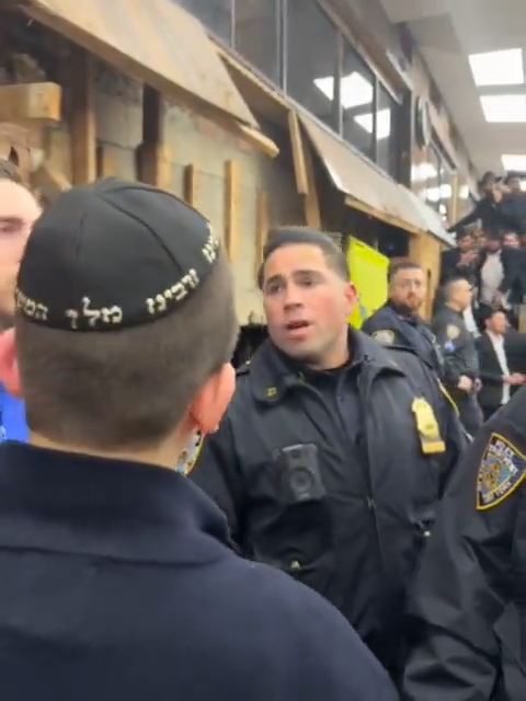 A cop is pictured speaking to one of the young men.
