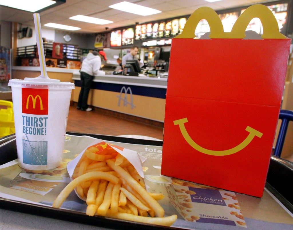 A McDonald's Happy Meal with french fries and a drink in a fast food restaurant