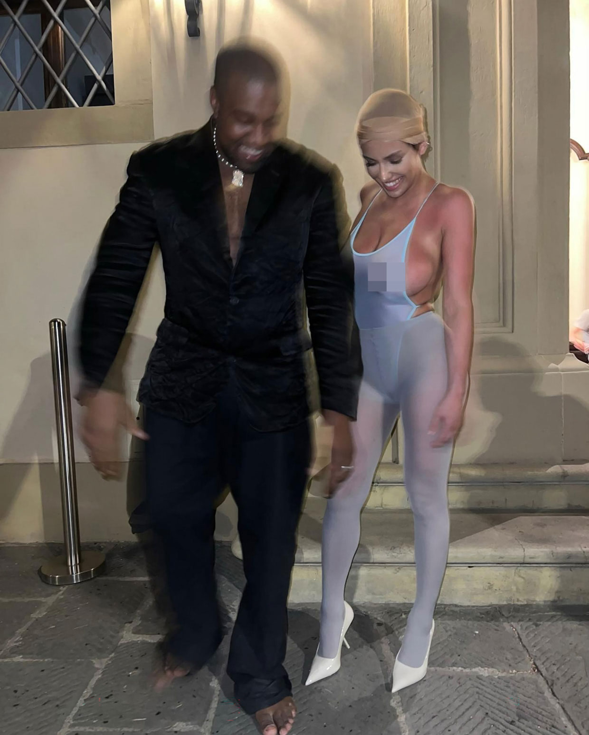 Kanye West and Bianca Censori pose for a photo.
