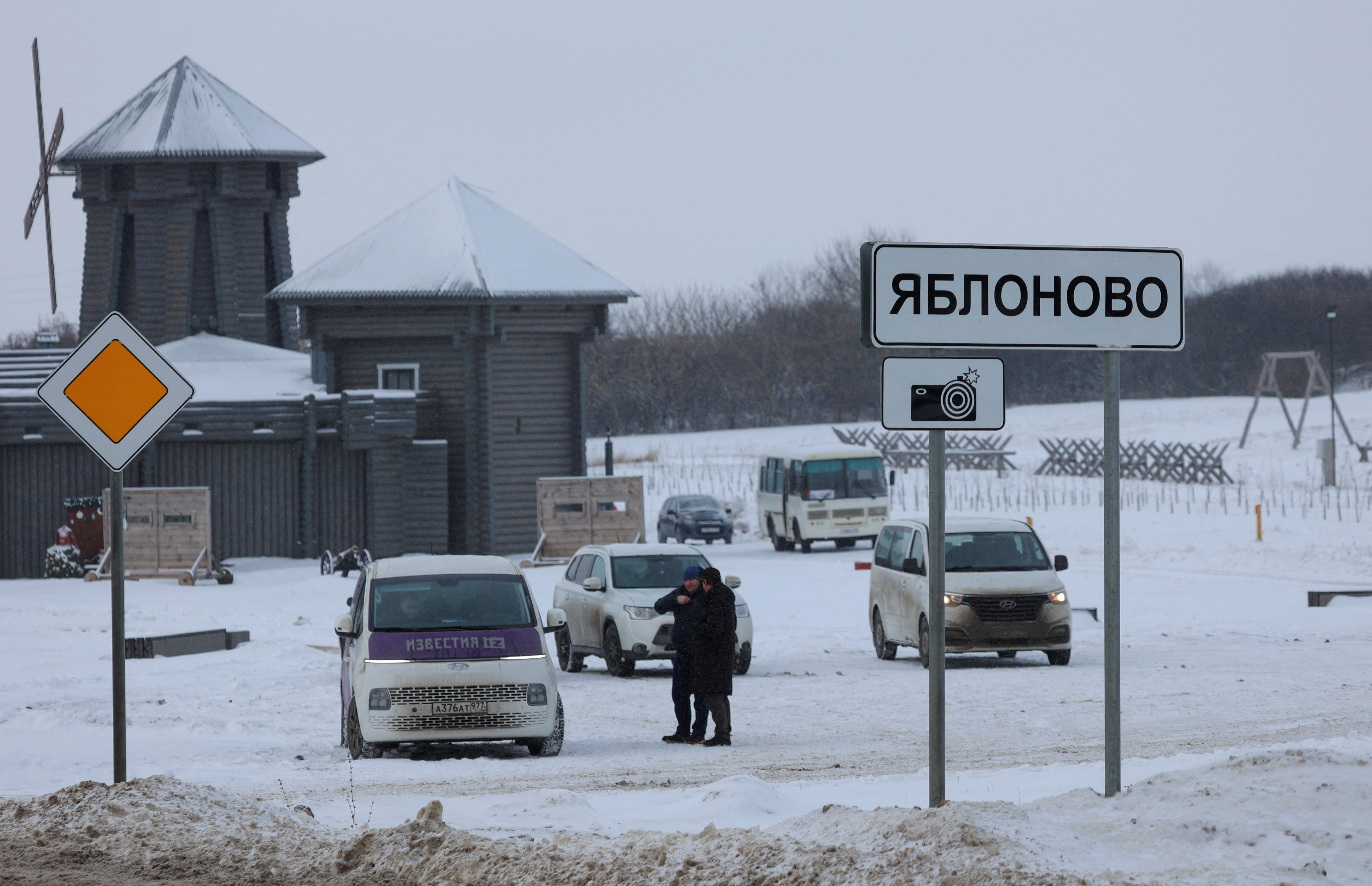 Vehicles are parked next to road near Russian Il-76 military plane crash site in Belgorod region