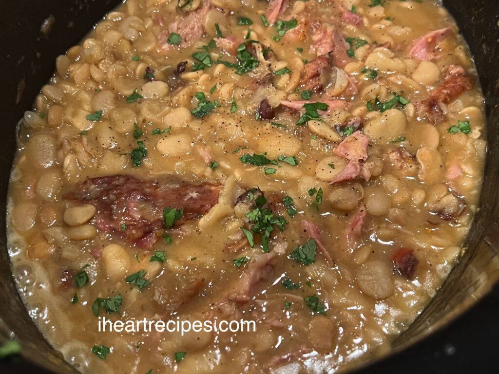 A pot full of creamy Southern Lima Butter Beans garnished with fresh parsley. 