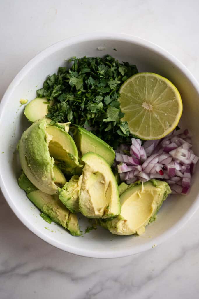 Guacamole ingredients in a bowl.