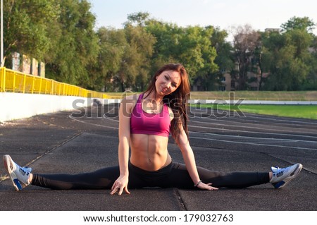 stock-photo-pretty-sporty-strong-slim-and-fit-young-woman-sitting-doing-split-and-stretching-exercises-179032763.jpg