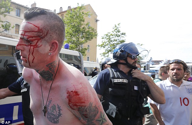 3528ADBA00000578-0-A_man_is_led_away_by_police_as_an_England_supporter_follows_in_t-a-6_1465800696025.jpg