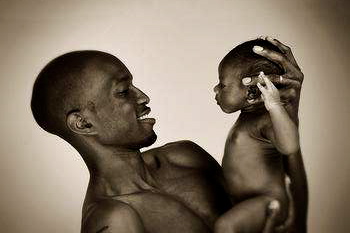 black_man_holding_baby_answer_1_xlarge.jpg