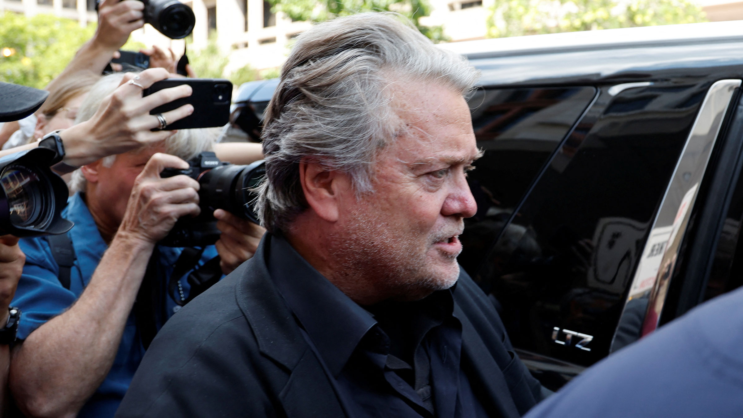 Steve Bannon is followed by the press as he leaves the courthouse on Friday.