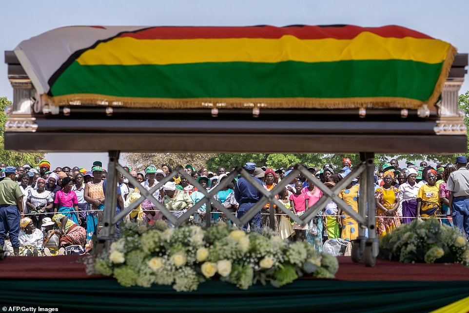19042298-7514931-Villagers_look_at_the_coffin_of_late_former_Zimbabwean_president-a-47_1569675691046.jpg