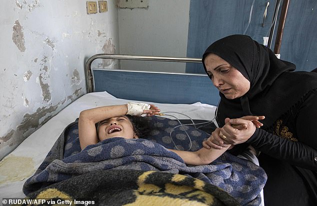 A girl who was injured in the ongoing Turkish offensive against Kurdish-controlled areas of northeastern Syria lying at a hospital in Tal Tamr, near the Syrian Kurdish town of Ras al-Ayn