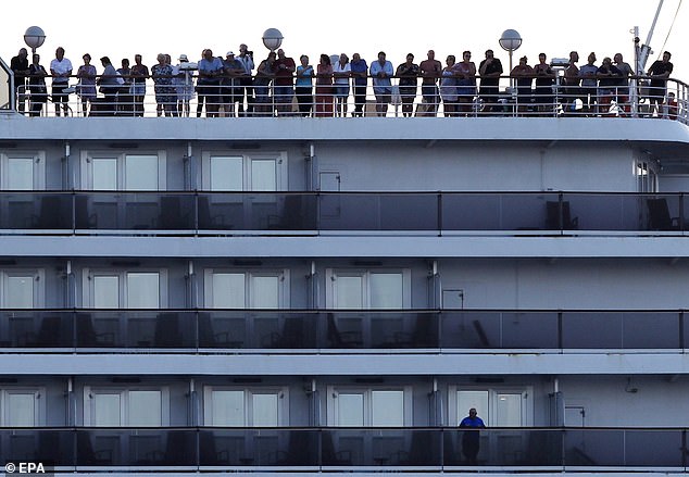 24704850-7999129-Passengers_stand_on_the_MS_Westerdam_cruise_ship_docked_at_a_sea-a-74_1581615078085.jpg