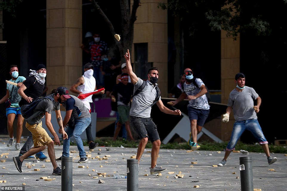 31715342-8607361-Demonstrators_hurl_stones_during_a_protest_near_the_parliament_b-a-49_1596900772262.jpg