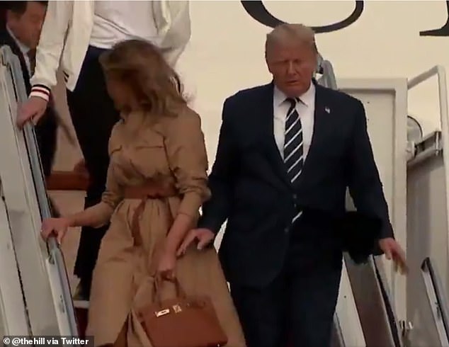 32050090-8635723-The_president_reached_out_again_but_Melania_kept_her_hand_tucked-m-7_1597678166405.jpg
