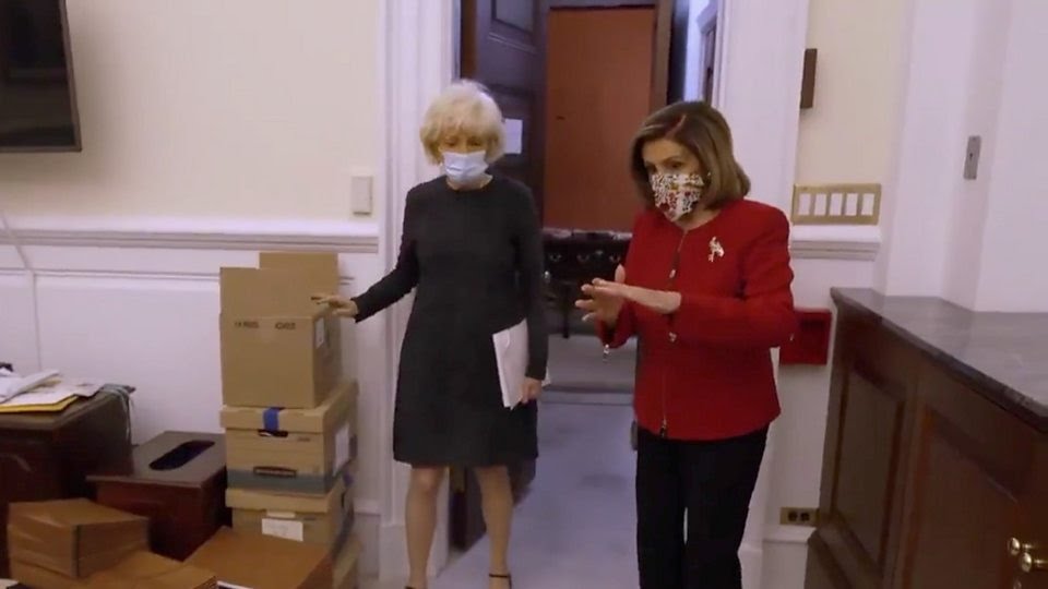 Speaker Nancy Pelosi walks through Capitol riots damage