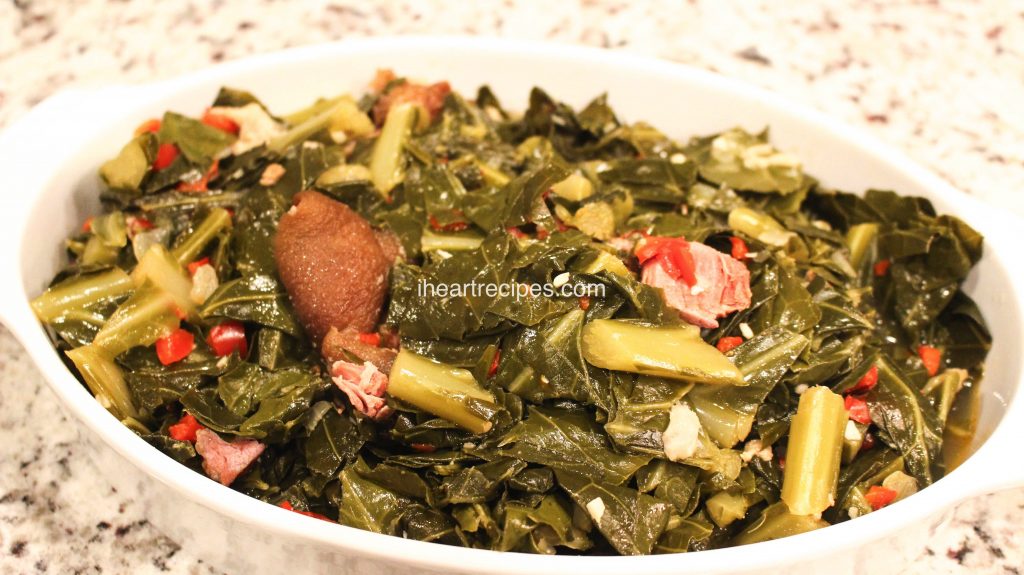 This soul food recipe for collard greens with ham hocks is seasoned to perfection with red peppers, onions, and garlic.