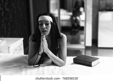 young-sexy-woman-nun-praying-260nw-768358150.jpg
