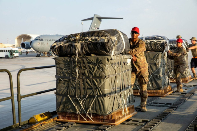  U.S. Air Force members work on the preparation of a humanitarian aid drop for Gaza residents, in this picture released on March 5, 2024.  (credit:  US Central Command via X/Handout via REUTERS )