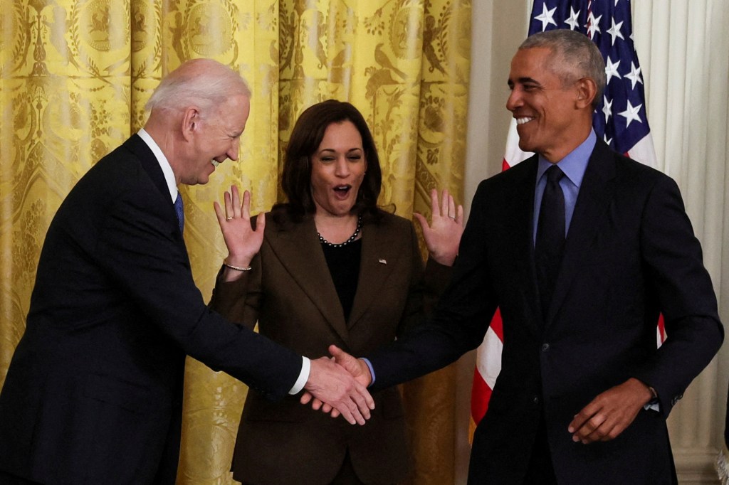 U.S. VPresident Joe Biden greets friend and former President Barack Obama during an event on the Affordable Care Act, the former president's top legislative accomplishment, as Vice President Kamala Harris reacts in the East Room at the White House in Washington, U.S., April 5, 2022. 