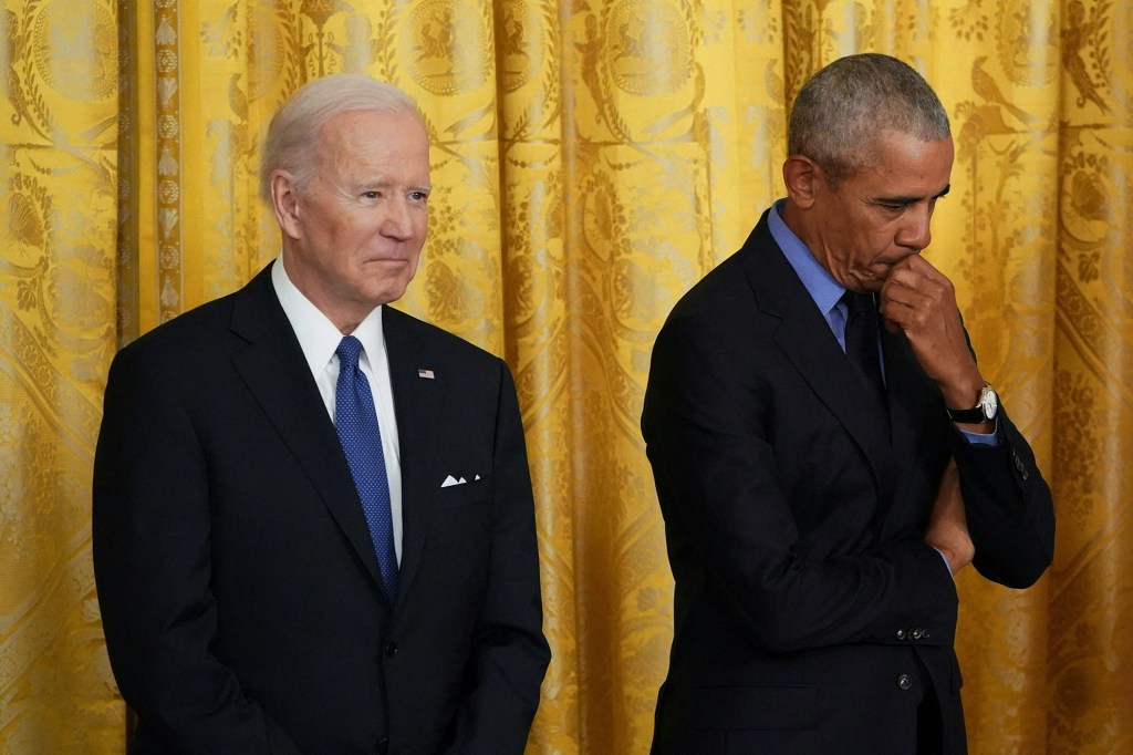 US President Joe Biden, and former President Barack Obama listen to US Vice President Kamala Harris (out of frame) speak on the Affordable Care Act and Medicaid in the East Room of the White House in Washington, DC, on April 5, 2022.