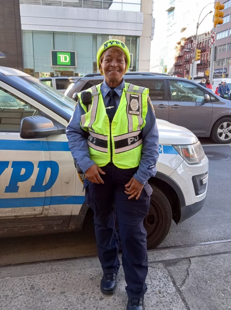 NYPD Traffic Agent Yvonne Llewellyn Campbell is pictured by an NYPD vehicle.