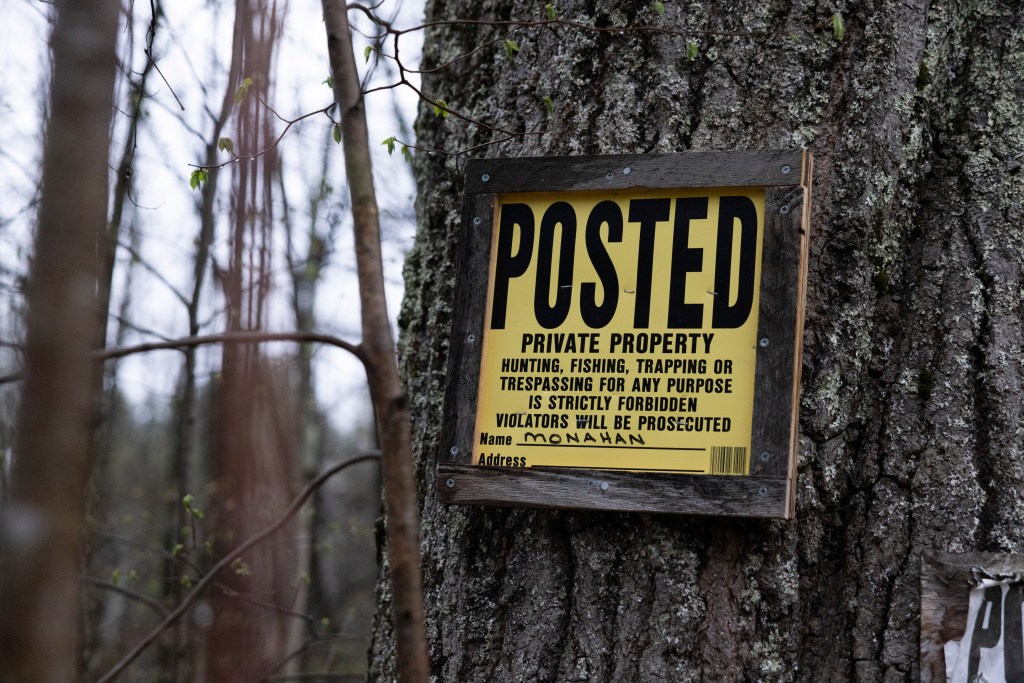 A warning posted on the property about trespassing.