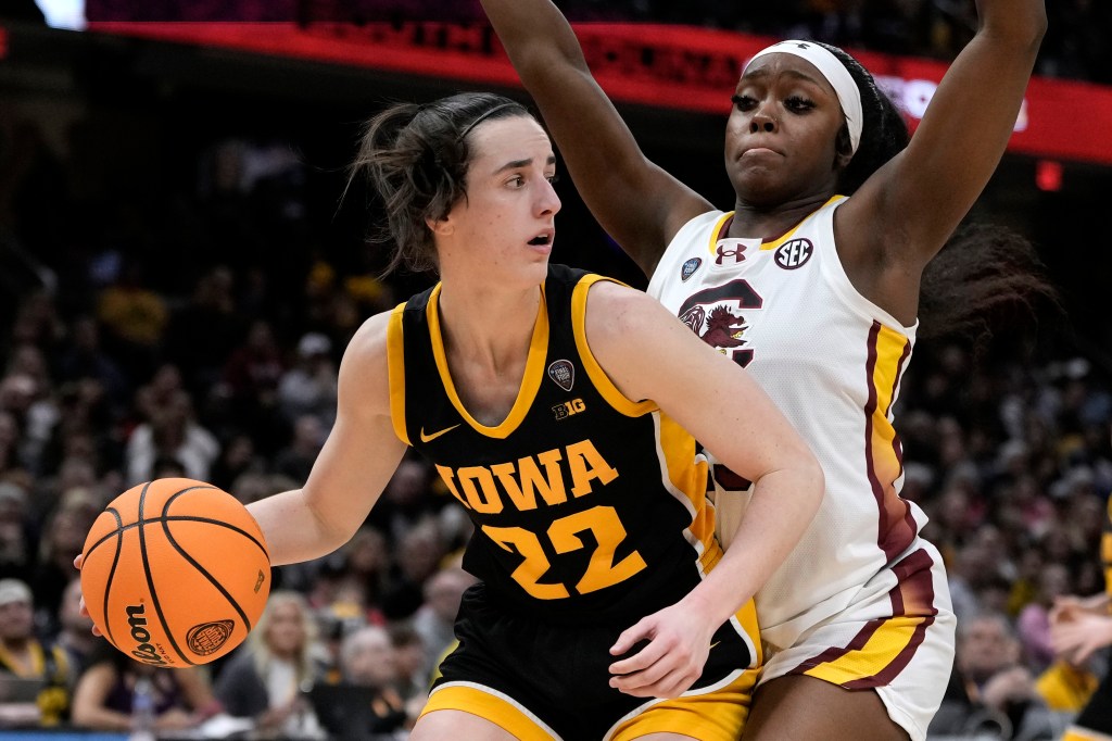 Iowa guard Caitlin Clark (22) dribbling past South Carolina guard Raven Johnson (25) during the second half of the Final Four college basketball championship game