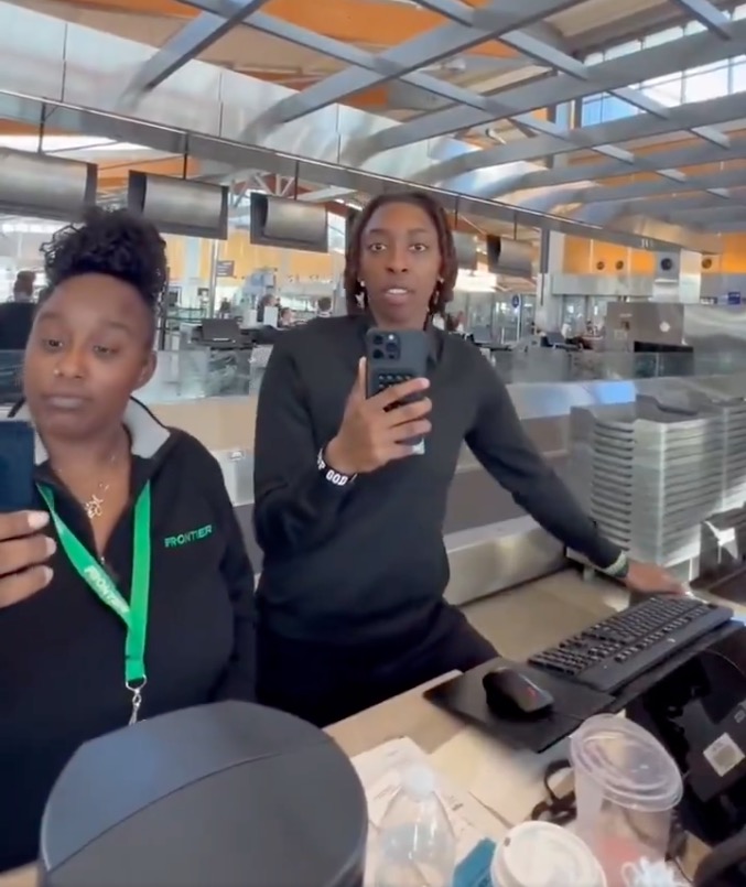 The footage shows the moment two of the agent's co-workers, who were dressed in long-sleeved black Frontier tops, chimed in and started pointing their own phones at him. The footage shows the moment two of the agent's co-workers, who were dressed in long-sleeved black Frontier tops, chimed in and started pointing their own phones at him.