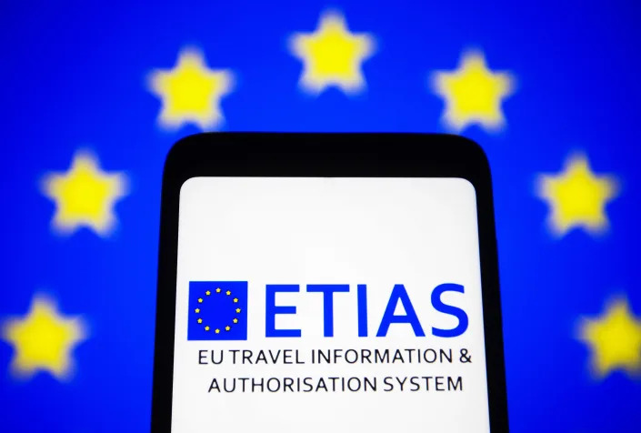 Photo Illustration of a device with the ETIAS site.