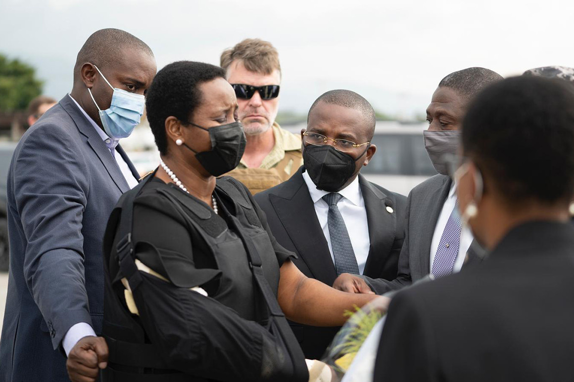 Haiti's first lady Martine Moise, wearing a bullet proof vest and her right arm in a sling, arrives at the Toussaint Louverture International Airport, in Port-au-Prince, Haiti.