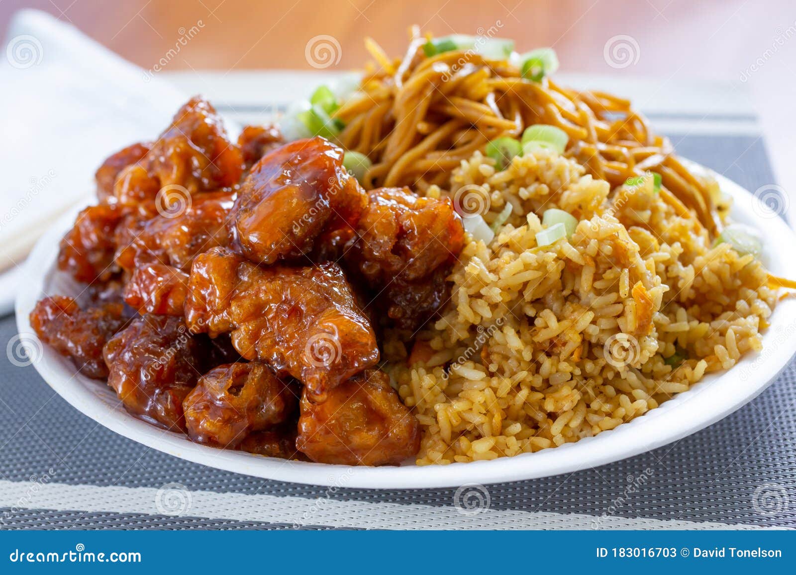 chinese-fast-food-combo-view-plate-restaurant-featuring-orange-chicken-chow-mein-fried-rice-183016703.jpg